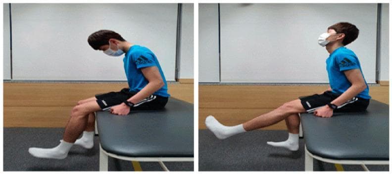This clinical photograph consists of a two-panel side-by-side comparison illustrating a neurodynamic training exercise, specifically a sciatic nerve slider or flossing technique. The subject is a male seated on a treatment table. In the left panel (starting position), the patient exhibits cervical flexion (chin to chest) with the trunk upright and both knees flexed at 90 degrees, feet resting on the floor. In the right panel (mobilization phase), the patient demonstrates simultaneous cervical extension (looking upward) and active right knee extension, with the ankle in neutral to slight dorsiflexion. This coordinated movement is designed to mobilize the neural tissues of the lower extremity, such as the sciatic nerve and its branches, without excessive tension. The images serve as an educational guide for physical therapy interventions targeting mechanosensitivity and range of motion in patients with chronic lumbar pain or radiculopathy. The subject is wearing a blue t-shirt, black shorts, and a face mask.